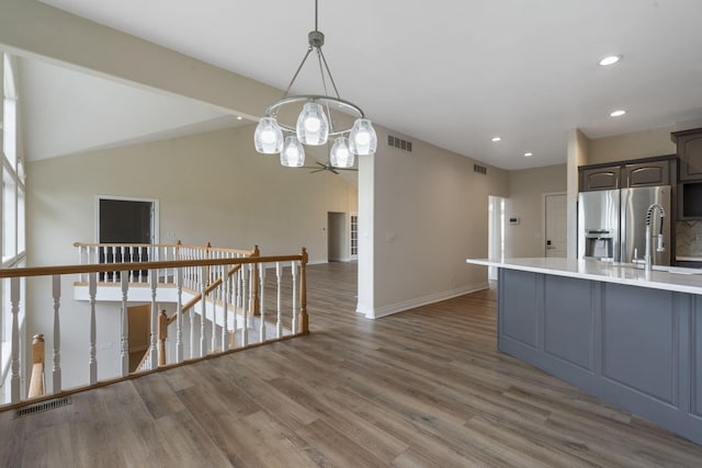 1007 Silvercrest Pl, Reeds Spring, MO 65737 - kitchen featuring stainless steel fridge, light countertops, wood finished floors, recessed lighting, and a chandelier