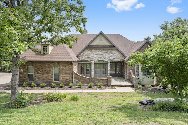 1007 Silvercrest Pl, Reeds Spring, MO 65737 - french provincial home featuring a front yard, french doors, a chimney, and stone siding