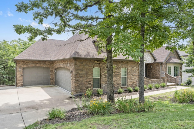 1007 Silvercrest Pl, Reeds Spring, MO 65737 - view of front of house with an attached garage, concrete driveway, a shingled roof, and brick siding