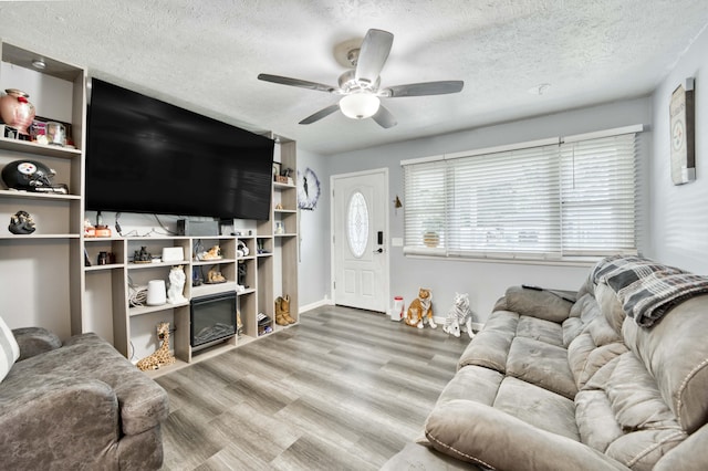 3153 W Washita St, Springfield, MO 65807 - living room with a ceiling fan, wood finished floors, and a textured ceiling
