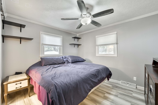 3153 W Washita St, Springfield, MO 65807 - bedroom with multiple windows, crown molding, light wood finished floors, a textured ceiling, and ceiling fan
