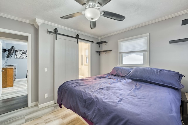3153 W Washita St, Springfield, MO 65807 - bedroom with wood finished floors, a barn door, crown molding, a ceiling fan, and connected bathroom