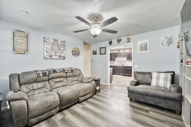 3153 W Washita St, Springfield, MO 65807 - living room with ceiling fan, light wood-type flooring, and a textured ceiling