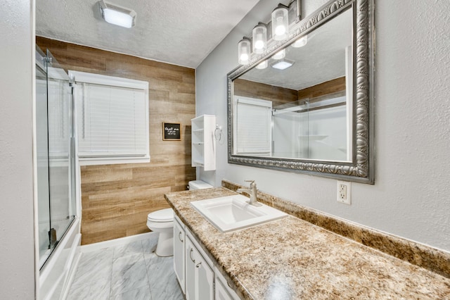 3153 W Washita St, Springfield, MO 65807 - full bathroom featuring vanity, marble look tiles, a textured ceiling, and enclosed tub / shower combo
