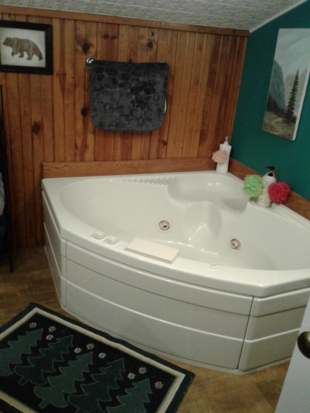 701 Spears Ave, Crane, MO 65633 - bathroom with a jetted tub and wooden walls