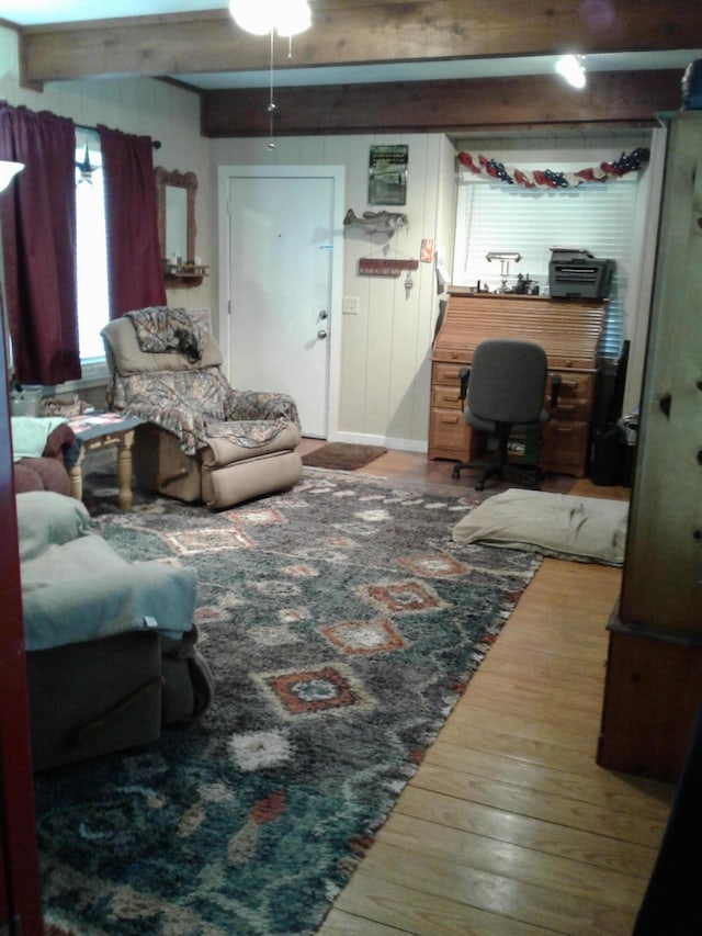 701 Spears Ave, Crane, MO 65633 - living area featuring wood-type flooring, beamed ceiling, and a ceiling fan