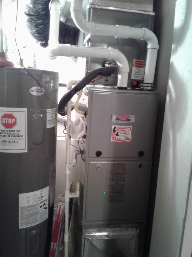 701 Spears Ave, Crane, MO 65633 - utility room with electric water heater and heating unit