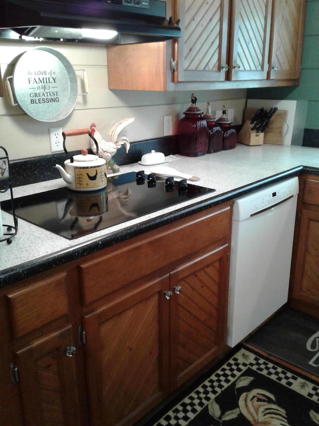 701 Spears Ave, Crane, MO 65633 - kitchen featuring white dishwasher, under cabinet range hood, black electric cooktop, and brown cabinets