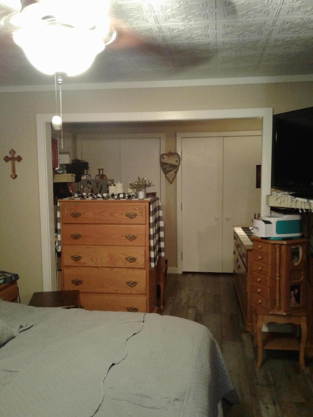 701 Spears Ave, Crane, MO 65633 - bedroom featuring wood finished floors, crown molding, and a closet
