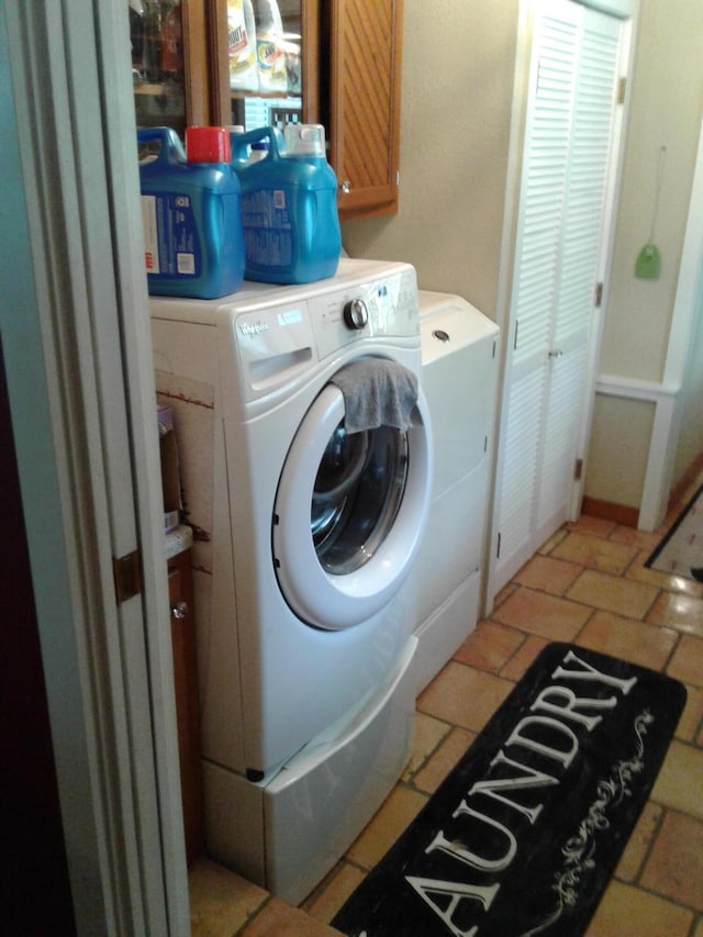 701 Spears Ave, Crane, MO 65633 - washroom with cabinet space and washing machine and dryer
