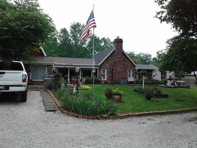 701 Spears Ave, Crane, MO 65633 - ranch-style home featuring brick siding, a chimney, and a front yard