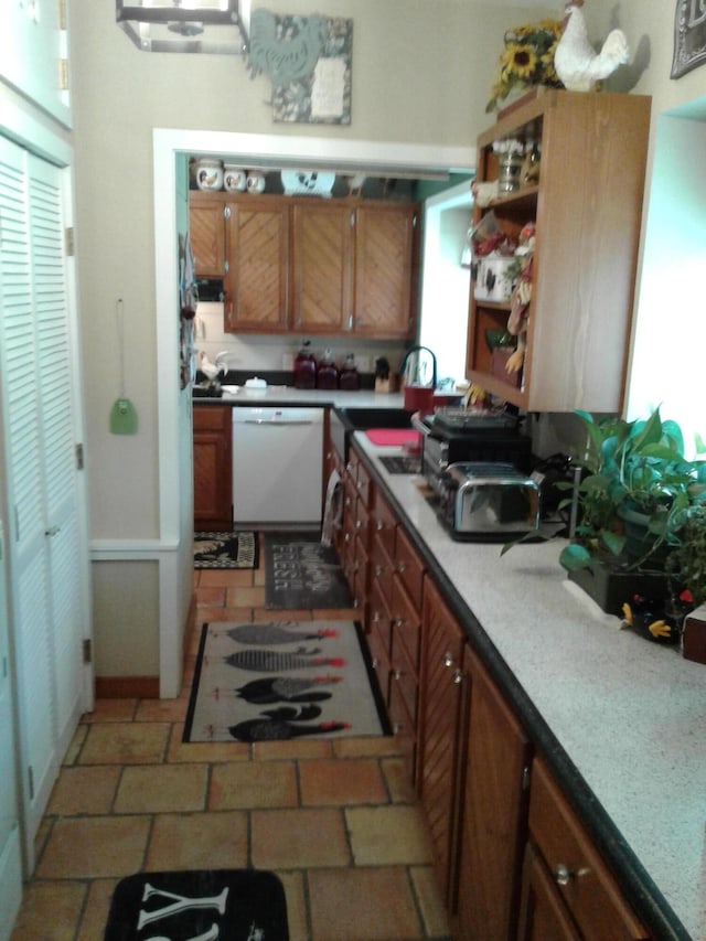 701 Spears Ave, Crane, MO 65633 - kitchen featuring white dishwasher, brown cabinetry, and open shelves