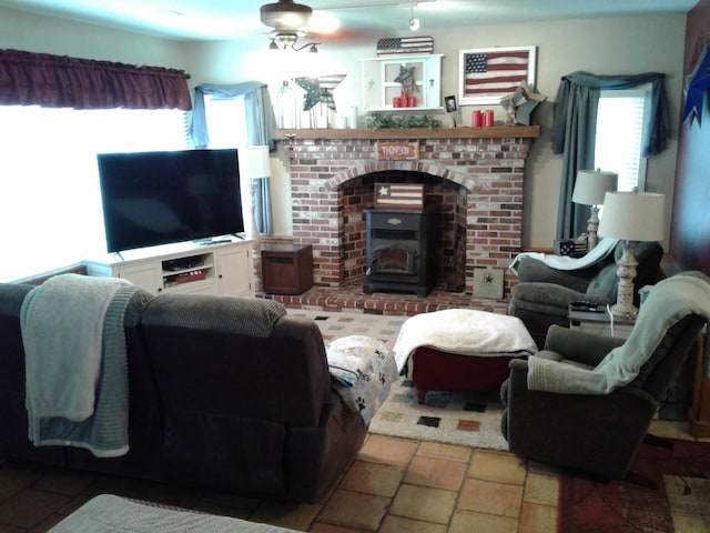 701 Spears Ave, Crane, MO 65633 - living room with ceiling fan, stone tile floors, and a wood stove