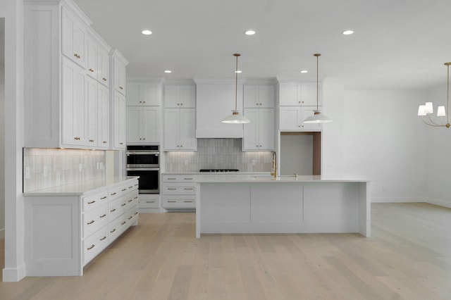 2124 N Silver Charm Ave, Springfield, MO 65802 - kitchen featuring gas cooktop, light wood-style floors, backsplash, stainless steel double oven, and recessed lighting