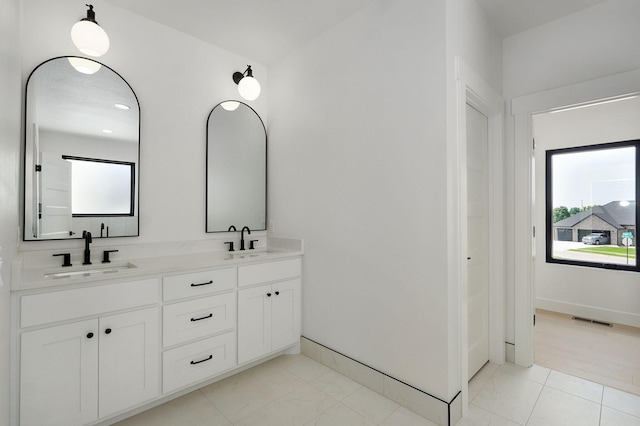 2124 N Silver Charm Ave, Springfield, MO 65802 - bathroom featuring double vanity and healthy amount of natural light