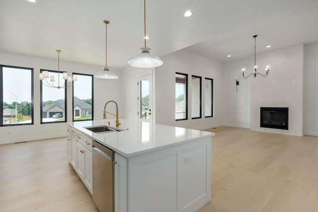 2124 N Silver Charm Ave, Springfield, MO 65802 - kitchen with stainless steel dishwasher, a chandelier, light wood-style flooring, a center island with sink, and recessed lighting