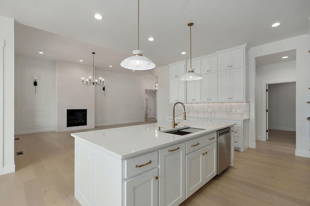 2124 N Silver Charm Ave, Springfield, MO 65802 - kitchen featuring stainless steel dishwasher, light wood-type flooring, decorative backsplash, white cabinetry, and recessed lighting