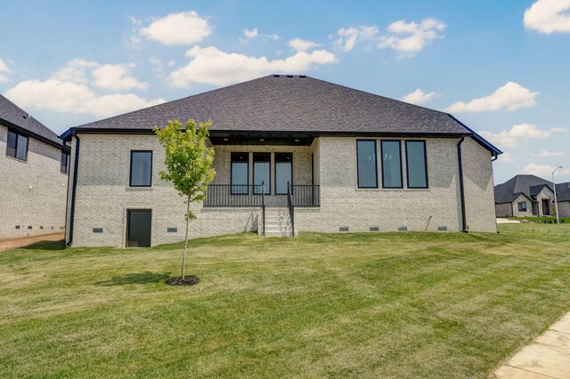 2124 N Silver Charm Ave, Springfield, MO 65802 - rear view of house featuring brick siding, a lawn, crawl space, and roof with shingles