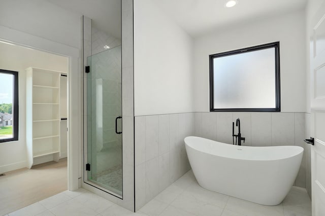2124 N Silver Charm Ave, Springfield, MO 65802 - bathroom with healthy amount of natural light, a shower stall, and a freestanding tub
