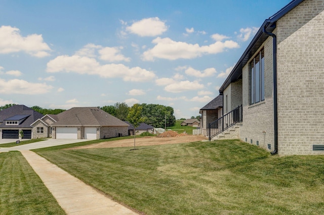 2124 N Silver Charm Ave, Springfield, MO 65802 - view of green lawn featuring a garage and a residential view