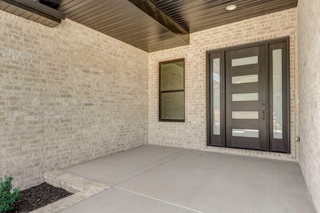 2124 N Silver Charm Ave, Springfield, MO 65802 - view of exterior entry featuring brick siding and a patio area