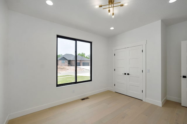 2124 N Silver Charm Ave, Springfield, MO 65802 - unfurnished bedroom featuring light wood-style flooring, recessed lighting, and a closet