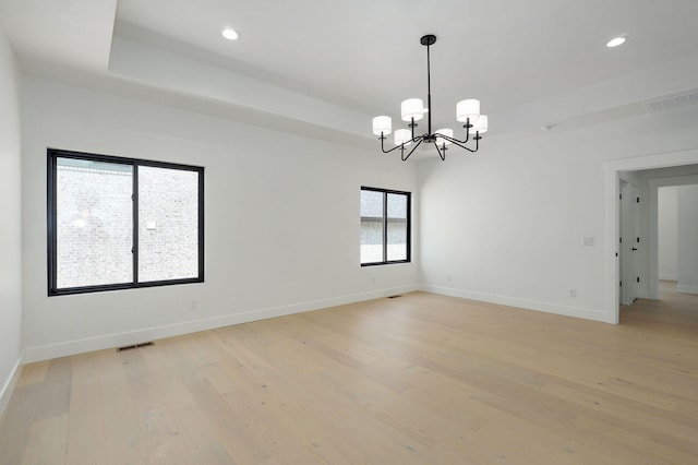 2124 N Silver Charm Ave, Springfield, MO 65802 - unfurnished room with a chandelier, light wood-style floors, recessed lighting, and a raised ceiling