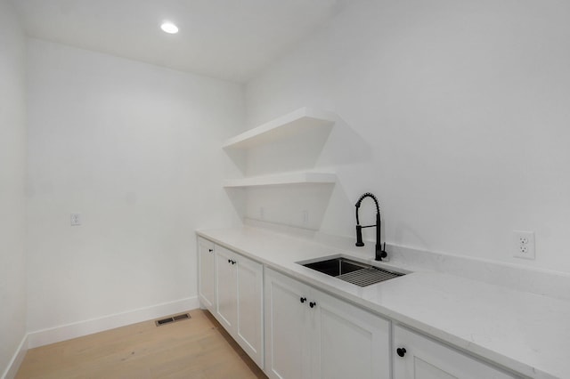 2124 N Silver Charm Ave, Springfield, MO 65802 - bar featuring light wood-type flooring and recessed lighting
