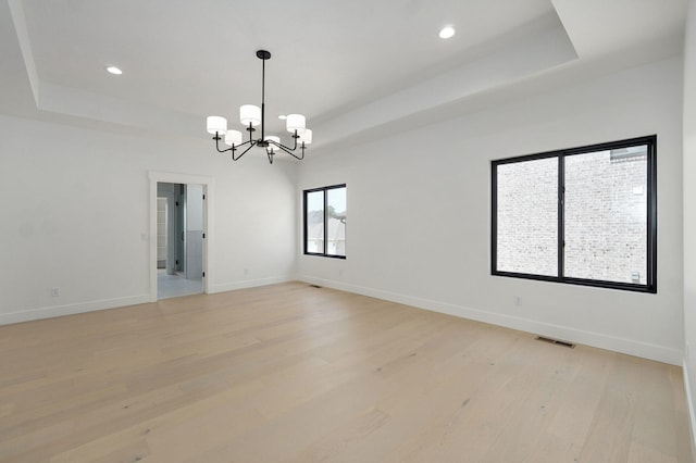 2124 N Silver Charm Ave, Springfield, MO 65802 - spare room featuring a raised ceiling, a chandelier, light wood finished floors, and recessed lighting