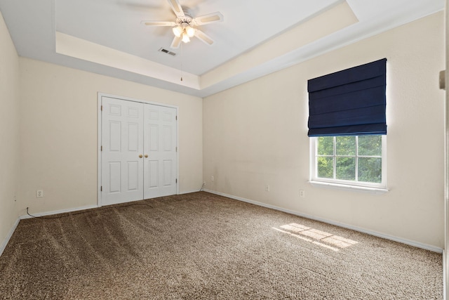280 Quail Run Rd, Branson, MO 65616 - unfurnished bedroom featuring carpet flooring, a tray ceiling, a closet, and ceiling fan