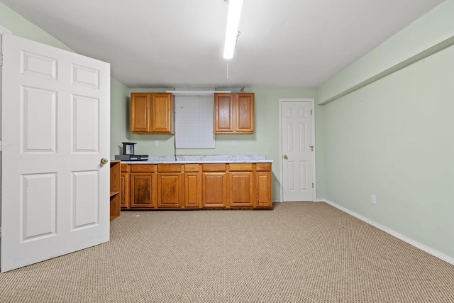 280 Quail Run Rd, Branson, MO 65616 - kitchen featuring light colored carpet, light countertops, and brown cabinets