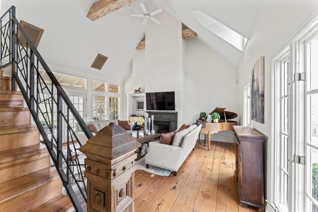 6420 E Turner Springs Rd, Springfield, MO 65809 - living area featuring high vaulted ceiling, stairs, beam ceiling, ceiling fan, and light wood-type flooring