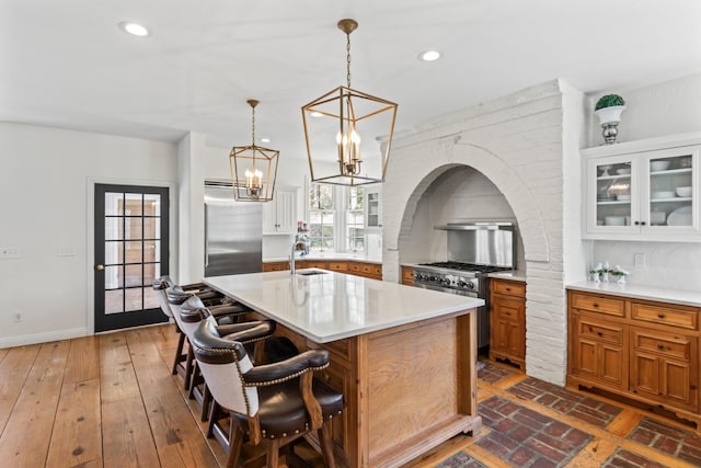 6420 E Turner Springs Rd, Springfield, MO 65809 - kitchen featuring high end appliances, brown cabinetry, light countertops, backsplash, and recessed lighting