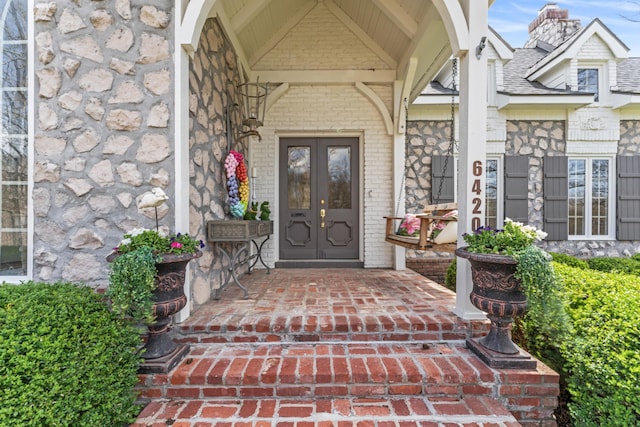6420 E Turner Springs Rd, Springfield, MO 65809 - property entrance with french doors, a chimney, brick siding, and stone siding