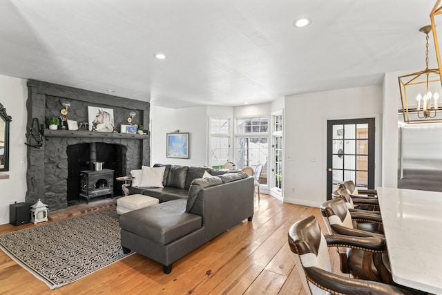 6420 E Turner Springs Rd, Springfield, MO 65809 - living room featuring light wood-type flooring, a chandelier, a wood stove, and recessed lighting