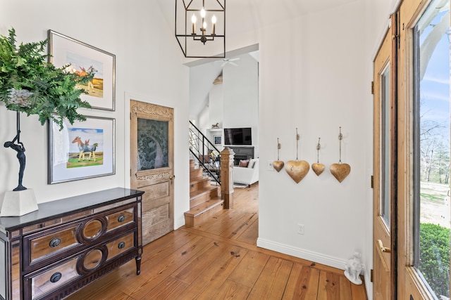 6420 E Turner Springs Rd, Springfield, MO 65809 - hall with hardwood / wood-style floors, a chandelier, stairs, and healthy amount of natural light