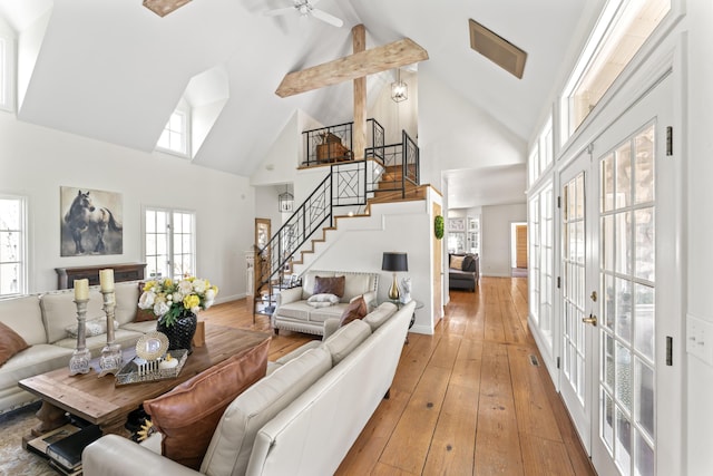 6420 E Turner Springs Rd, Springfield, MO 65809 - living room featuring high vaulted ceiling, stairway, plenty of natural light, light wood finished floors, and beam ceiling