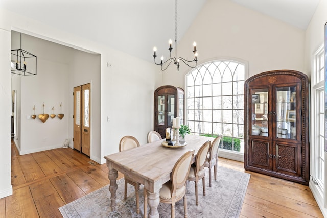 6420 E Turner Springs Rd, Springfield, MO 65809 - dining area featuring a chandelier, light wood finished floors, and high vaulted ceiling