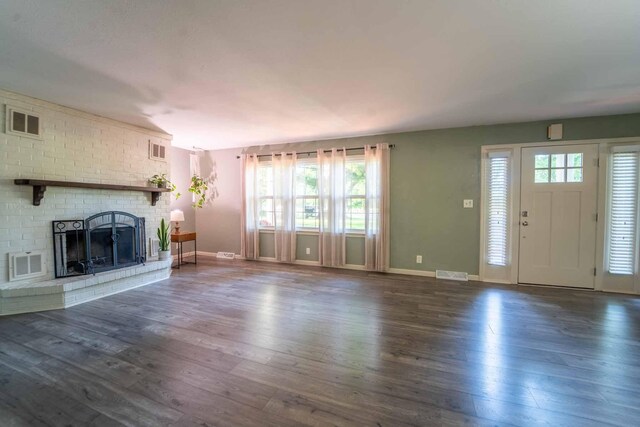 600 E Boone St, Ash Grove, MO 65604 - unfurnished living room featuring wood-type flooring and a fireplace