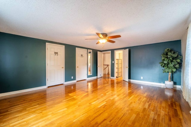 600 E Boone St, Ash Grove, MO 65604 - unfurnished bedroom with a textured ceiling, light wood finished floors, and ceiling fan
