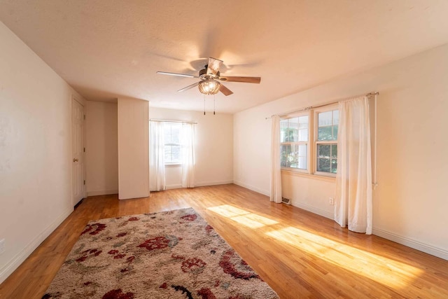 600 E Boone St, Ash Grove, MO 65604 - empty room with light wood-style flooring and a ceiling fan