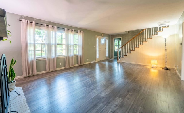 600 E Boone St, Ash Grove, MO 65604 - unfurnished living room with healthy amount of natural light, wood finished floors, and stairway