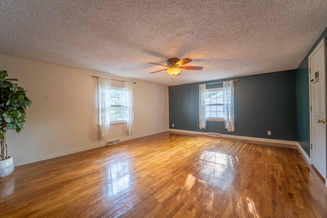 600 E Boone St, Ash Grove, MO 65604 - spare room with ceiling fan, light wood finished floors, and a textured ceiling