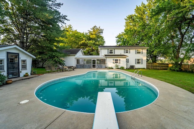 600 E Boone St, Ash Grove, MO 65604 - view of pool with a sunroom, a diving board, a patio, and an outdoor structure