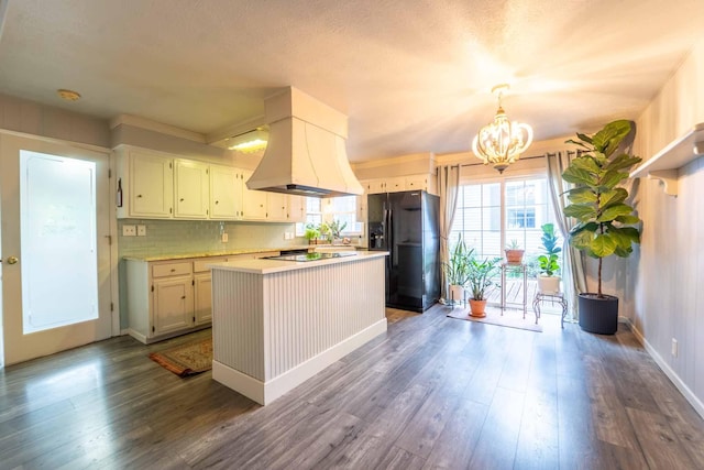 600 E Boone St, Ash Grove, MO 65604 - kitchen featuring black appliances, custom exhaust hood, dark wood-type flooring, a chandelier, and light countertops
