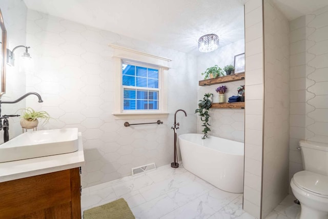 600 E Boone St, Ash Grove, MO 65604 - bathroom featuring vanity, marble finish flooring, and a freestanding tub