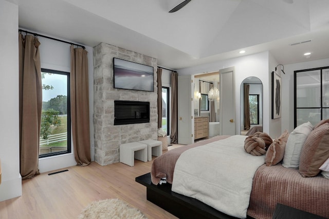 12451 State Highway 174, Billings, MO 65610 - bedroom featuring a large fireplace, light wood-style flooring, vaulted ceiling, recessed lighting, and connected bathroom