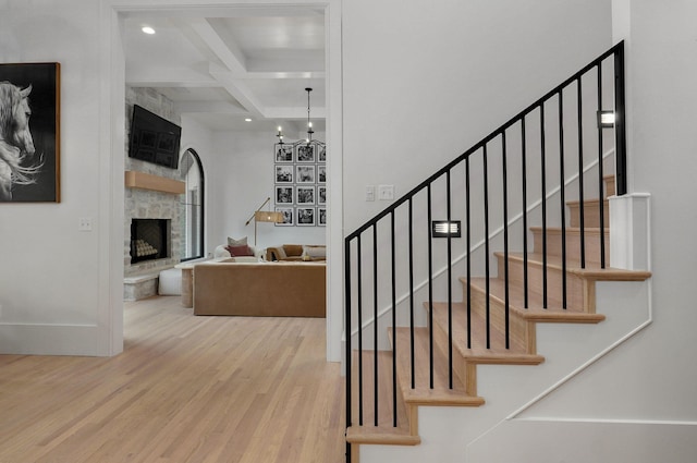12451 State Highway 174, Billings, MO 65610 - staircase with wood finished floors, beamed ceiling, a stone fireplace, a chandelier, and recessed lighting