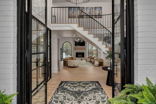 12451 State Highway 174, Billings, MO 65610 - entrance foyer featuring french doors, wood finished floors, a high ceiling, a fireplace, and stairs