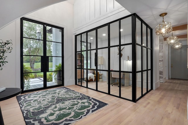 12451 State Highway 174, Billings, MO 65610 - doorway with healthy amount of natural light, wood finished floors, a high ceiling, a chandelier, and french doors